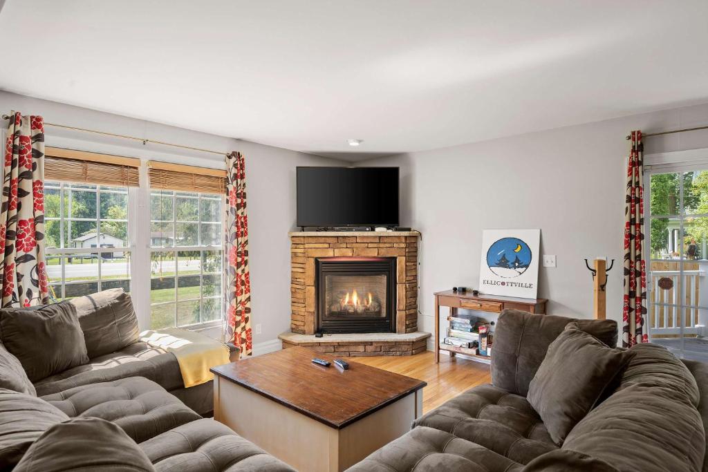 a living room with a couch and a fireplace at Family Friendly Spacious 4BR Townhome Hot Tub less than 1 mile to town in Ellicottville