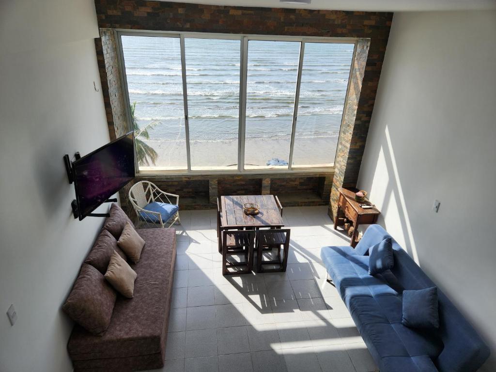 a living room with a view of the ocean at TUCACAS PENTHOUSE VISTA AL MAR y SALIDA A LA PLAYA in Tucacas