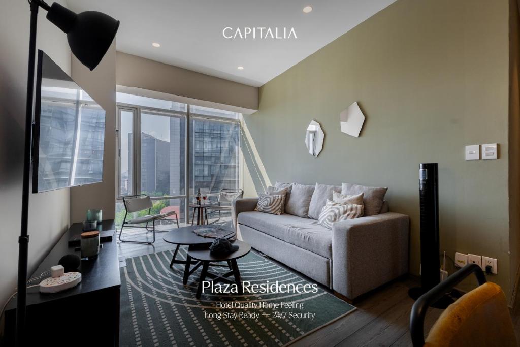 a living room with a couch and a table at Capitalia Plaza Residences Reforma in Mexico City