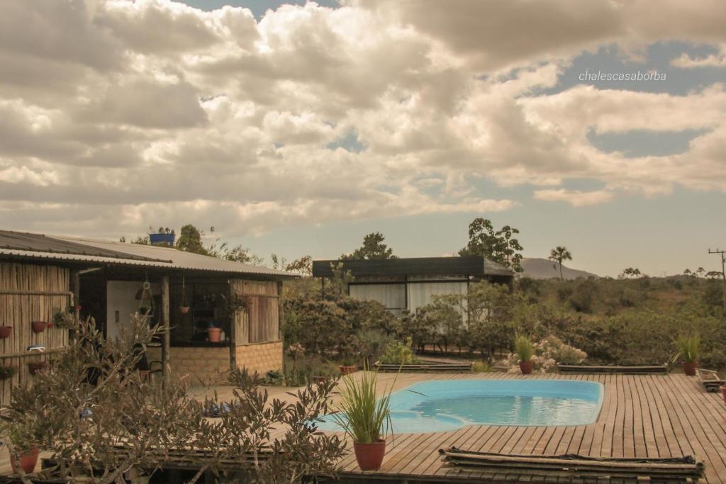 a swimming pool in front of a house at Casa Borba Chalé encantador in Alto Paraíso de Goiás