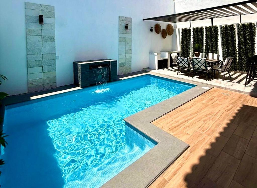 a large blue swimming pool with a fireplace at Casa al Mare in Mazatlán