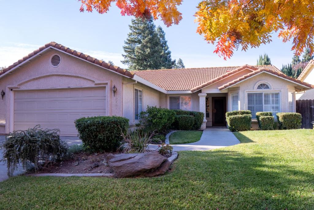 a house with a garage in a yard at Modern Merced Haven near Merced College and UC Merced in Merced