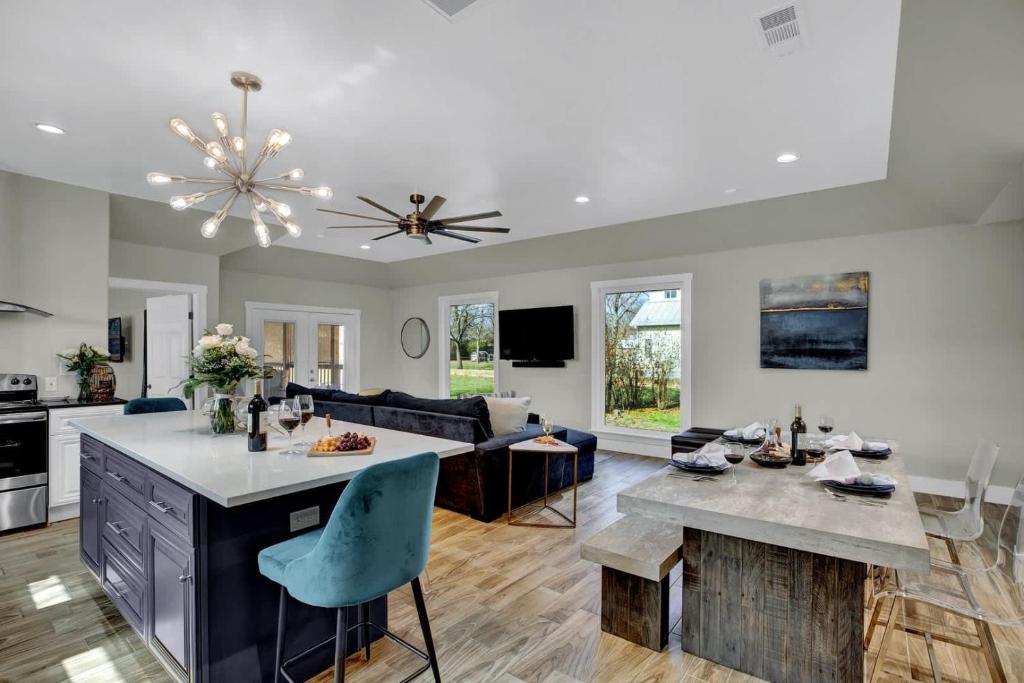 a kitchen and living room with a table and a couch at Chateau De Callis - Hot Tub & 1 Block to Main St in Fredericksburg