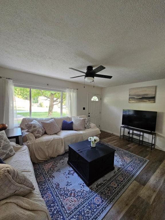 a living room with a couch and a flat screen tv at Cozy 3BR Cottage Near Headlands in Mentor