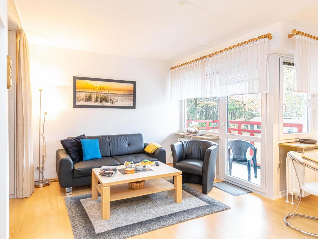 a living room with a couch and chairs and a table at Terrassenhaus - 9 in Cuxhaven