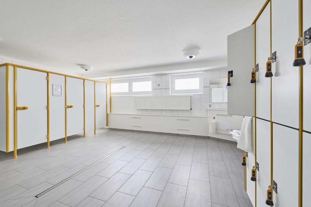 baño grande con paredes blancas y puertas amarillas en Knechtsand - 441, en Cuxhaven