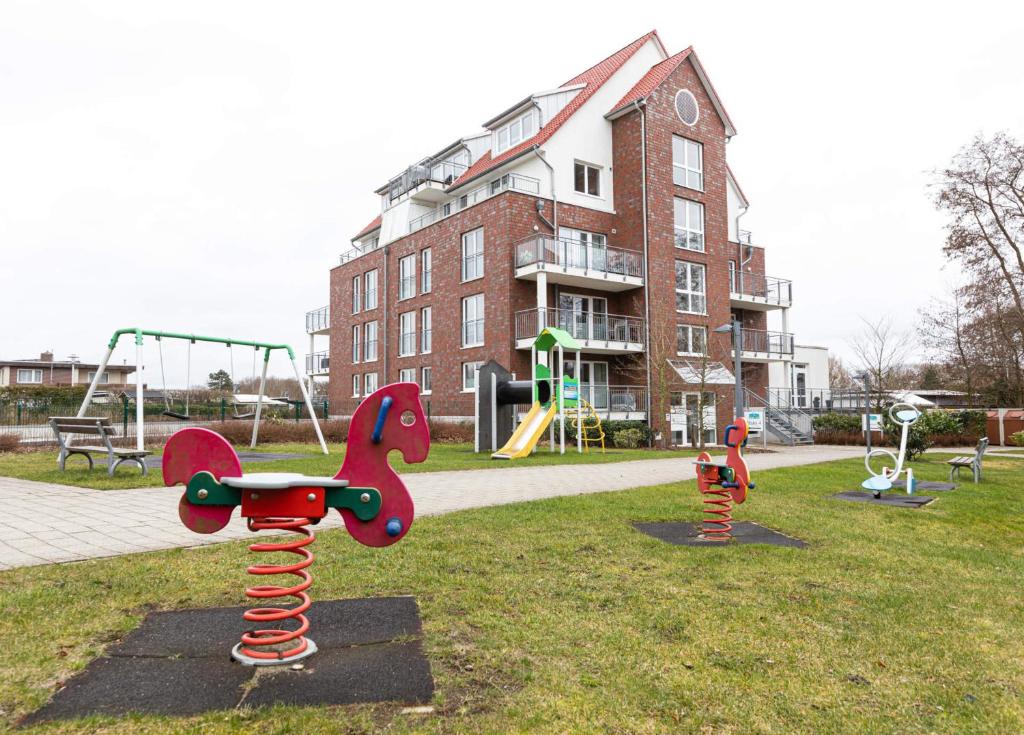 a park with playground equipment in front of a building at Hohe Lith - 335 in Cuxhaven