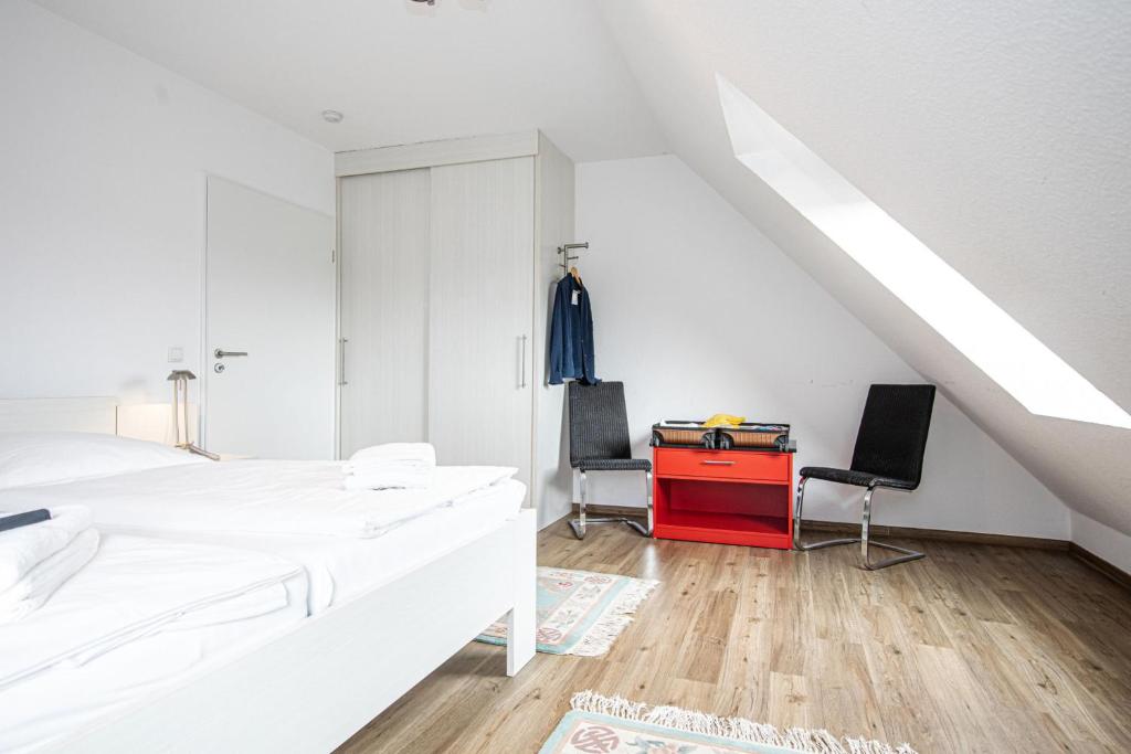 a bedroom with two beds and a red desk at Hohe Lith - 335 in Cuxhaven