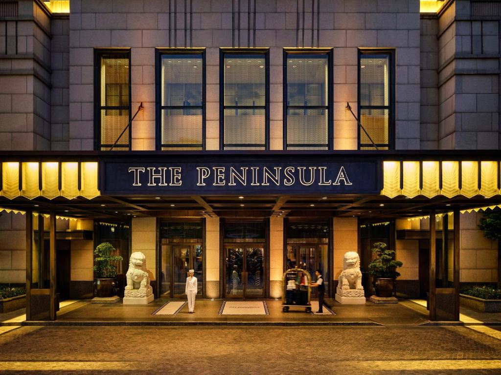 a building with a sign that reads the penn institution at The Peninsula Shanghai in Shanghai