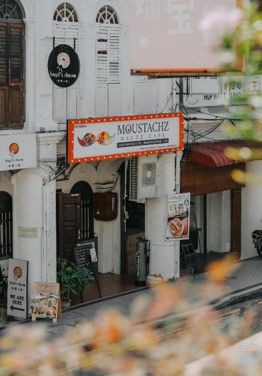 a building with a sign for a restaurant at Moustachz Hauze , Georgetown in George Town