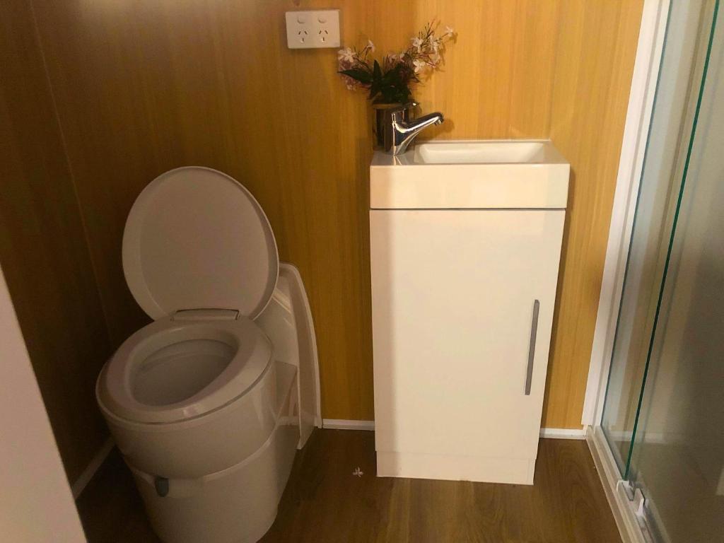 a bathroom with a toilet and a sink at Cedar Creek Falls by Tiny Away in Eagle Heights