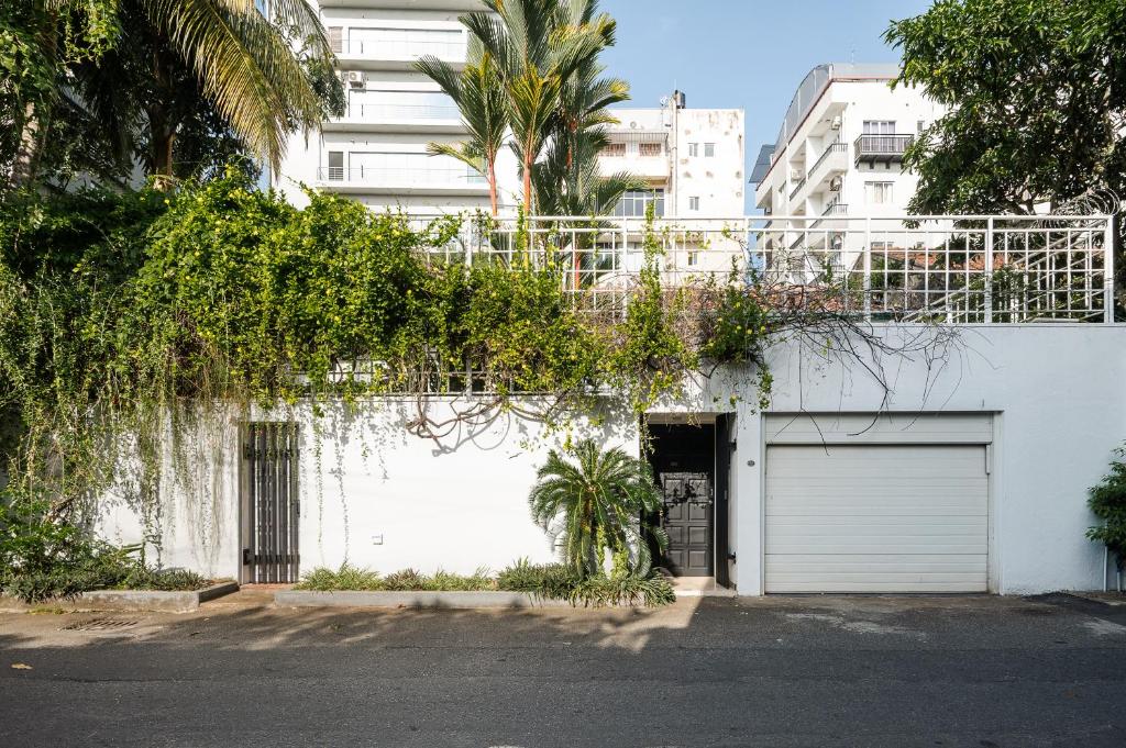 a white building with a gate and a garage at Jetwing Ratnam Residence in Colombo