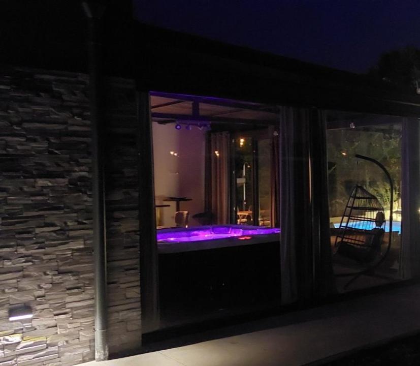 a room with a tub with purple lights in it at Casa di Ljubica - Private paradise in Pula - Luxury and romance for couples, jacuzzi, massage, pool, bbq and fenced yard in Pula