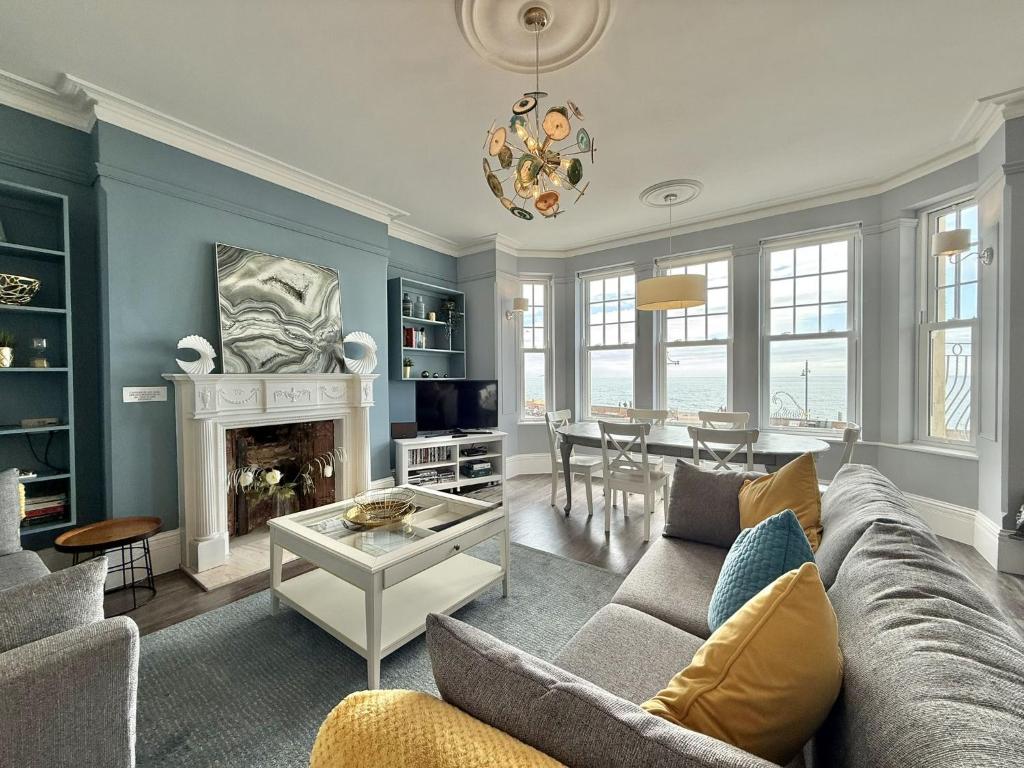 a living room with a couch and a fireplace at The Eastleigh in Seaton