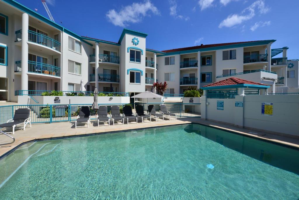a swimming pool in front of a apartment building at Paradise Isles in Gold Coast