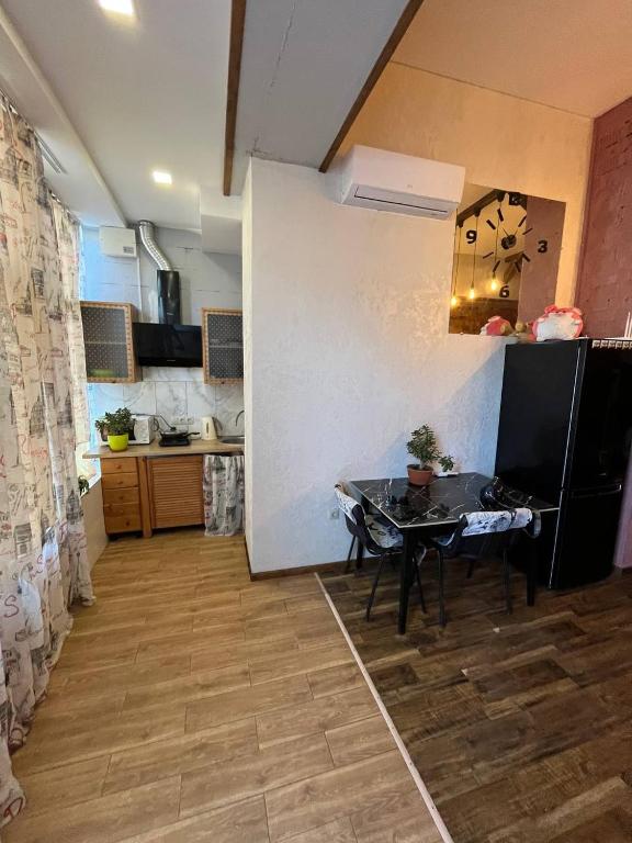 a kitchen with a table in the middle of a room at Стадия лофт 2 in Chornomorsk