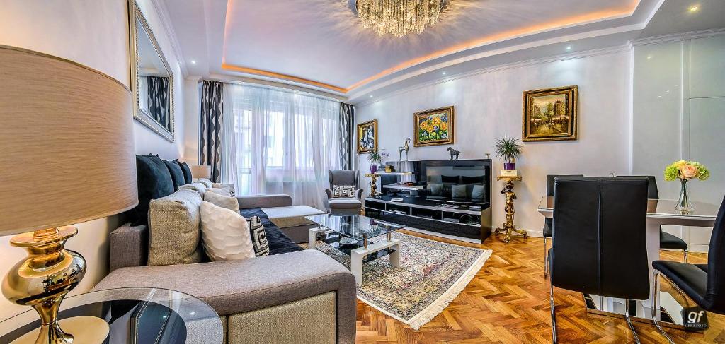a living room with a couch and a television at VIP Apartments Budapest in Budapest