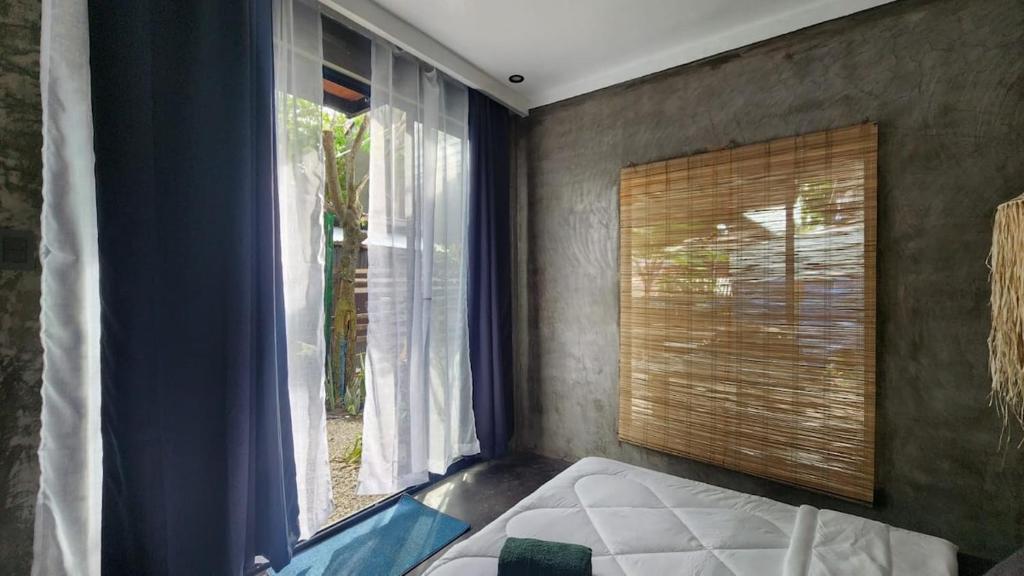 Ένα ή περισσότερα κρεβάτια σε δωμάτιο στο Pura Vida - General Luna