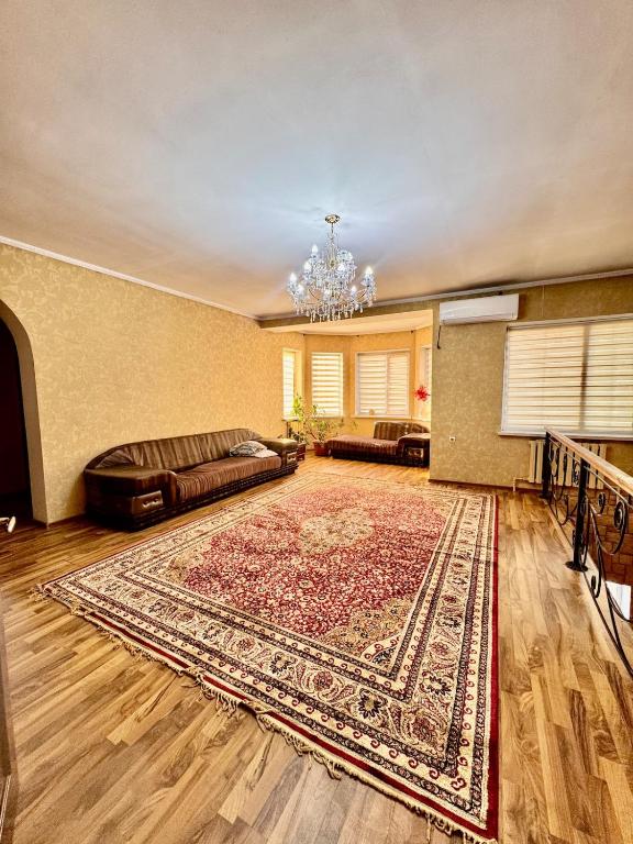 a living room with a couch and a rug at Cottage Лома city center 7 to 2 floor in Taldykorgan