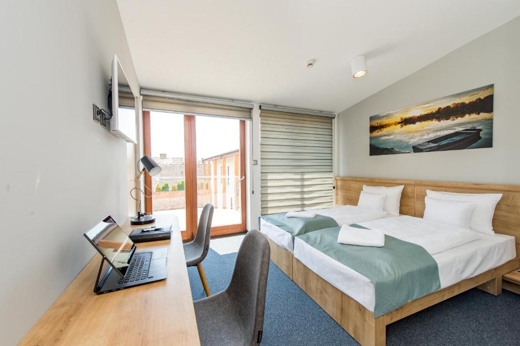 Postel nebo postele na pokoji v ubytování Pilvax Hotel Kalocsa