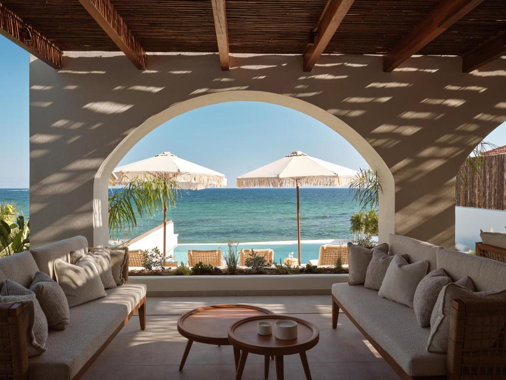 a living room with a view of the beach at Oriana, Beachfront villa in Zakynthos Town