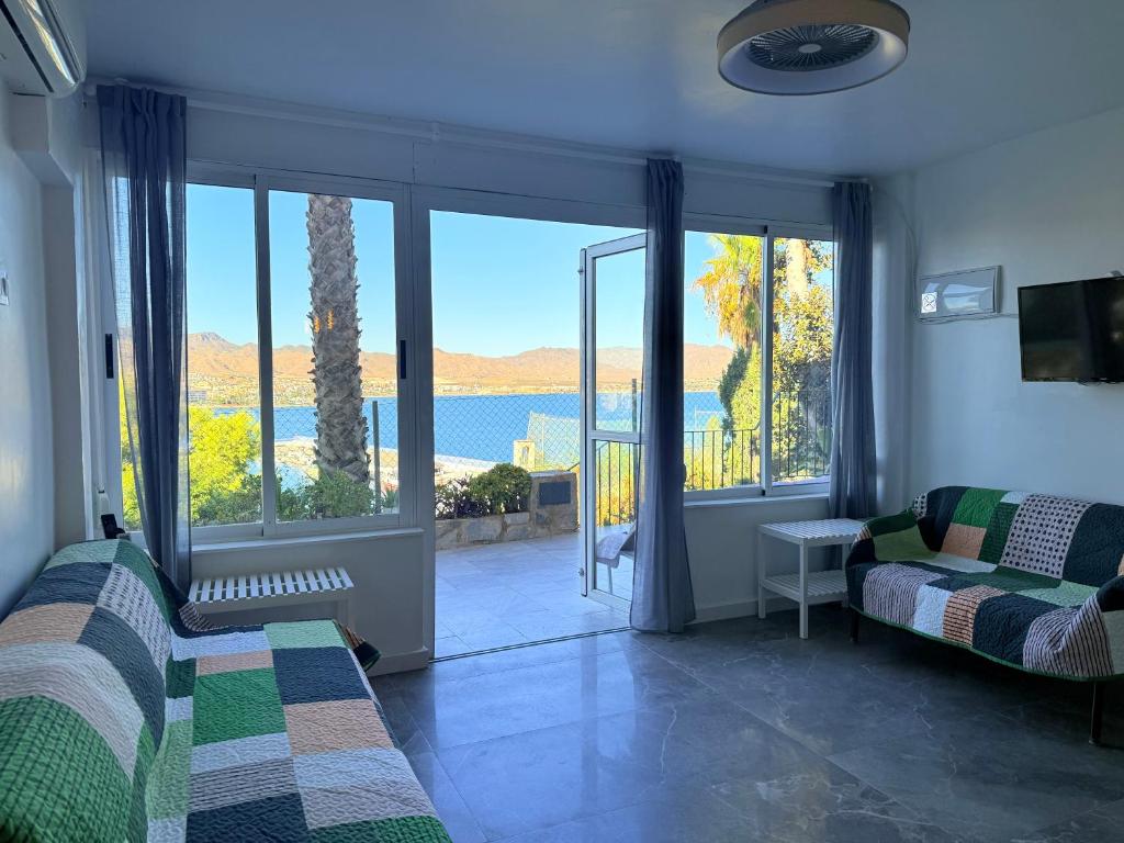 a room with two beds and a view of the water at Mirador del Mar in Puerto de Mazarrón