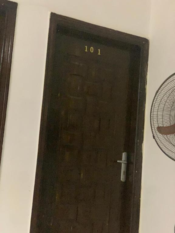 a black door with the number on it at Golden Sand Pyramids in Cairo