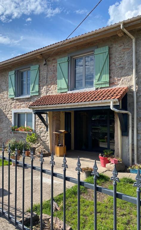 a house with a fence in front of it at Gîte PREY DES VOSGES in Prey