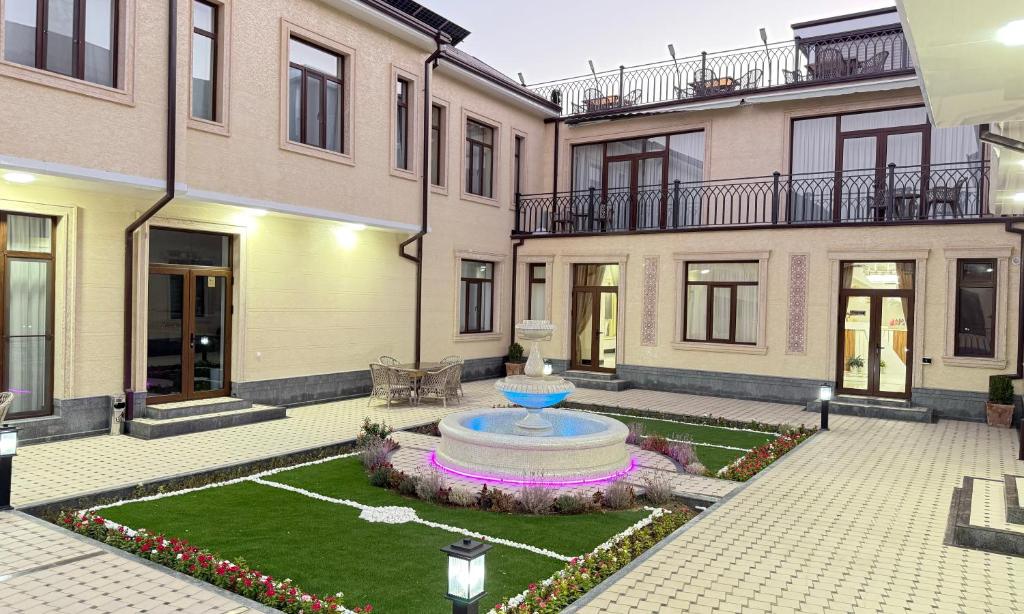 Un patio con una fuente en el medio de un edificio. en Mubina East Hotel, en Bukhara