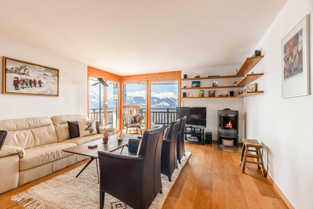 a living room with a couch and a table at Ski Paradise SP 009 - MOUNTAIN apartment 4 pers in Veysonnaz