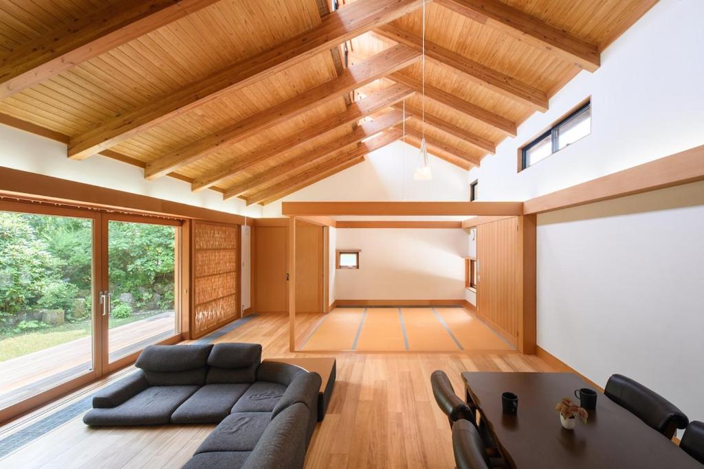 a living room with a couch and a table at 箱根こもれび庵 in Hakone