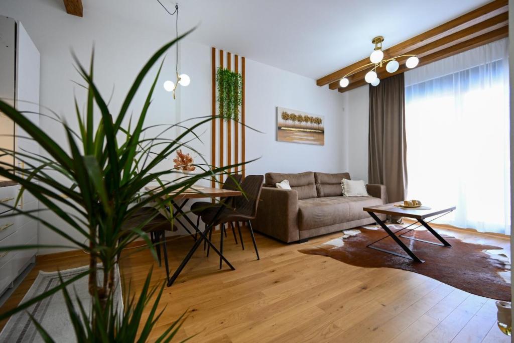 a living room with a couch and a table at Apartman Borova Oaza in Zlatibor