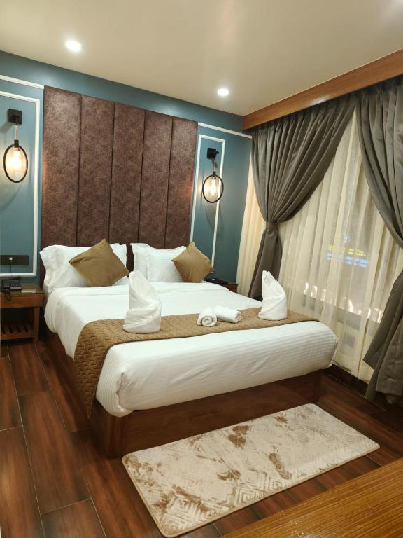 a bedroom with a large bed in a room at The House Hotel Darjeeling in Darjeeling