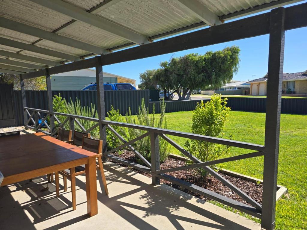 a patio with a table and a fence at Sea Breeze in Lancelin