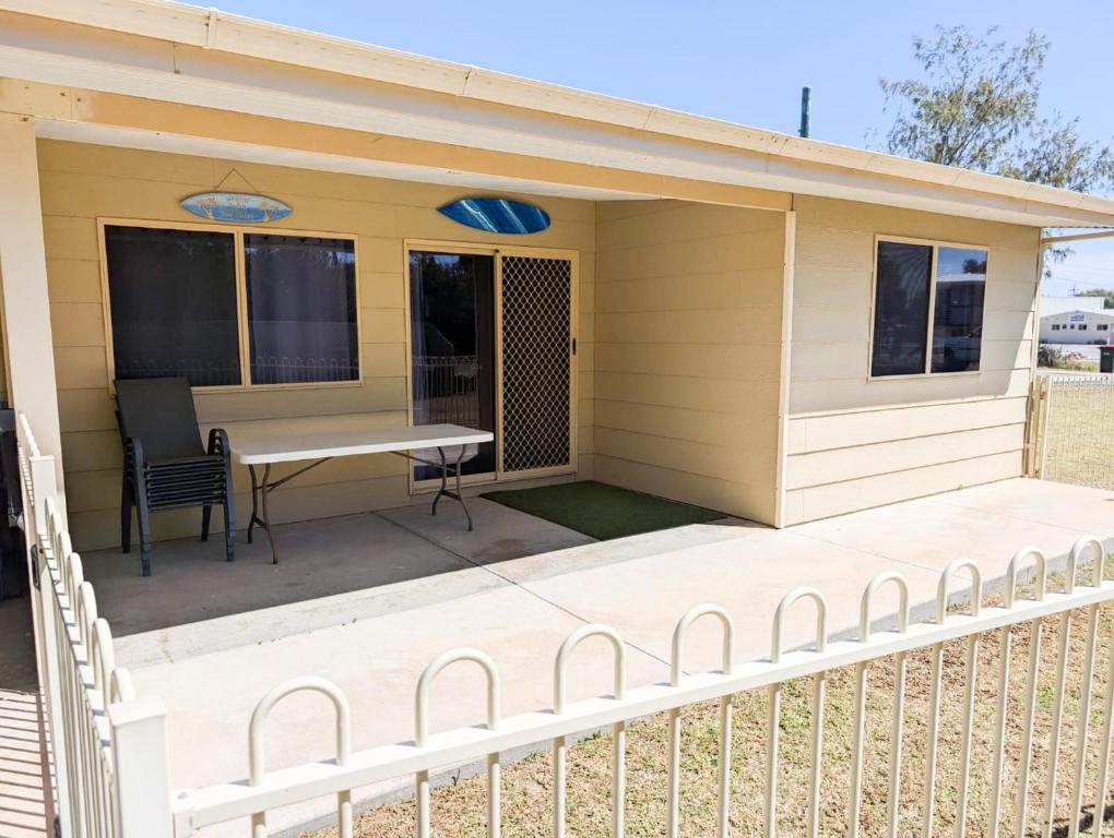a house with a table and chairs on a porch at Aqua Sands Chalets in Lancelin