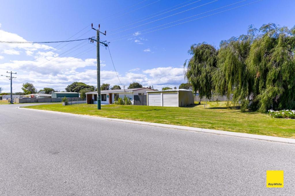 an empty road with a house and a tree at Sea Gem in Lancelin