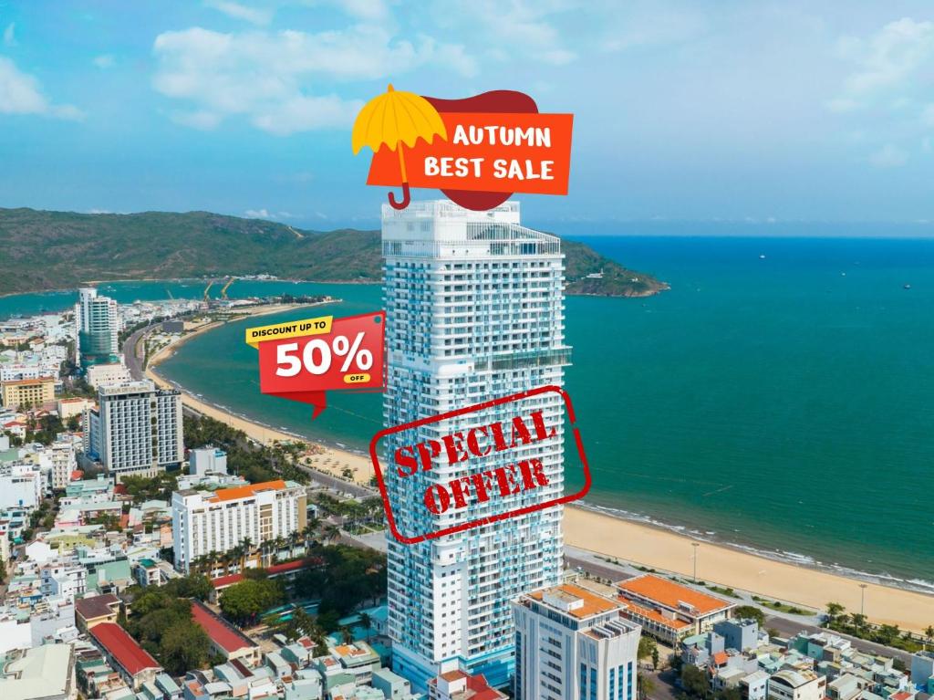 an apartment building with an umbrella on top of it at TMS Beachfront Apartment Quy Nhon Bay in Quy Nhon