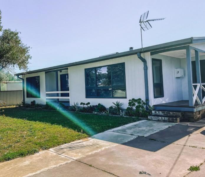 a house with a rainbow in front of it at The Newby in Lancelin