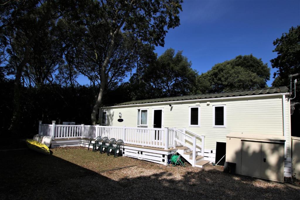 a white trailer with a porch and a house at Harbourside in Christchurch