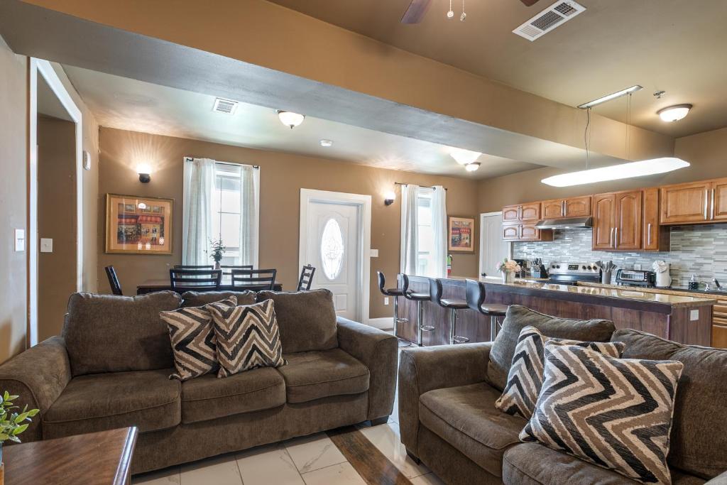 a living room with two couches and a kitchen at Baronne Street Spacious and Fully Furnished Condo in New Orleans