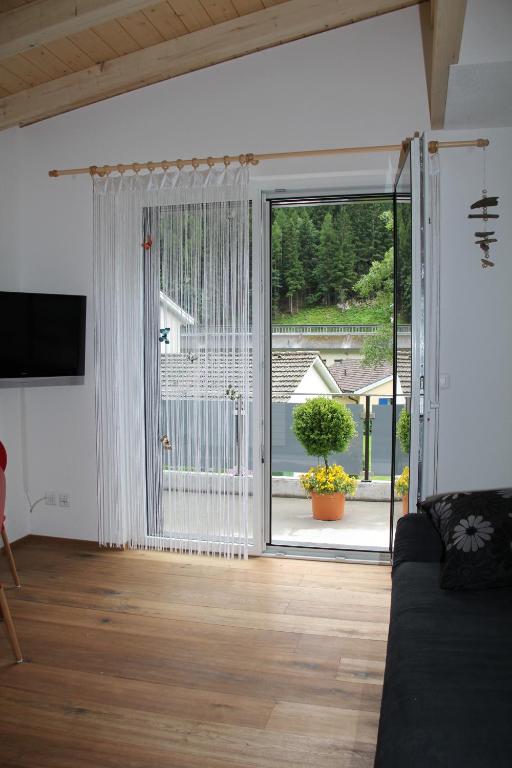 a living room with a large sliding glass door at Haus Steiner in Göschenen
