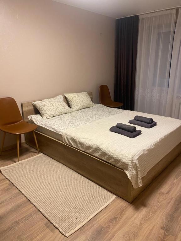 a bedroom with a bed with two towels on it at Апарт Безручка in Rivne