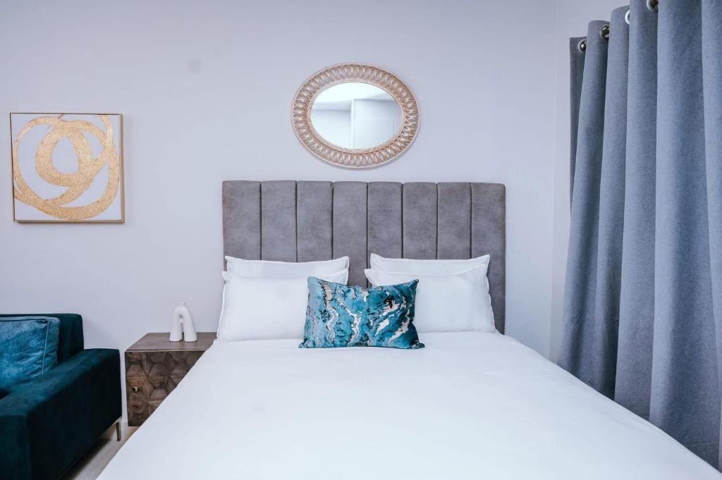 a bedroom with a large bed and a mirror at Lanekwa's in Gaborone