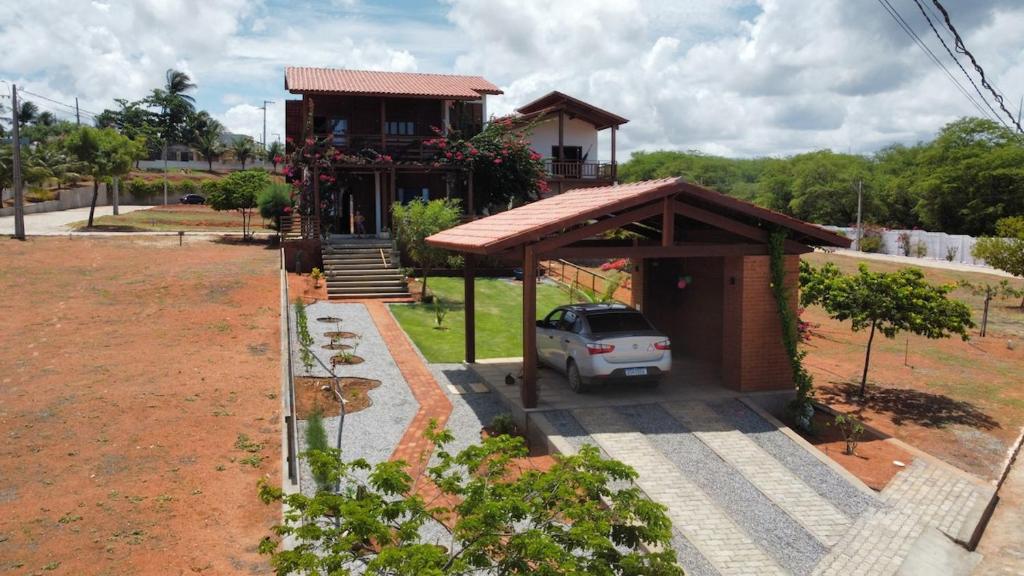 a car parked in front of a house at Beautiful house in the paradise of São Cristóvão RN in Areia Branca