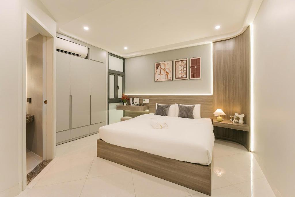 a bedroom with a white bed and a bathroom at HoanKiemlake-Oldquarter-Elevator in Hanoi