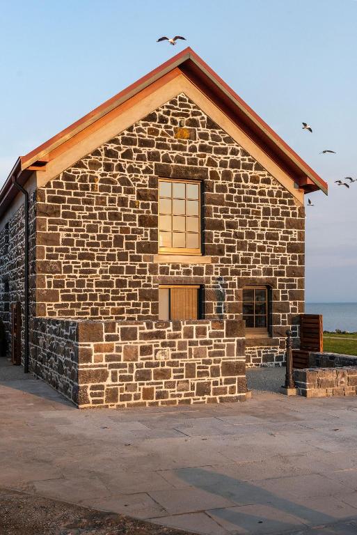 a brick building with a window on the side of it at Bond Store Stanley in Stanley
