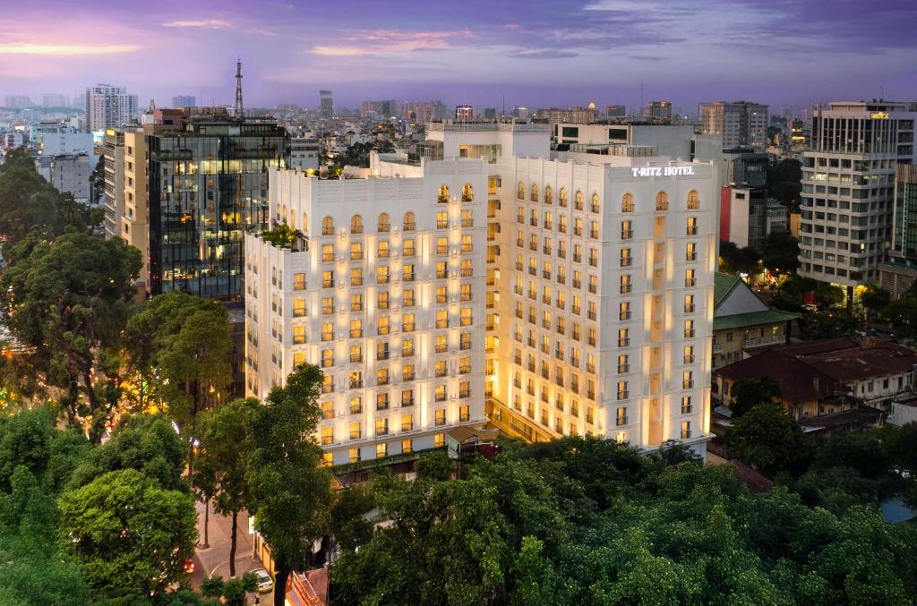 a large white building in the middle of a city at T-Ritz Saigon Hotel & Apartment in Ho Chi Minh City