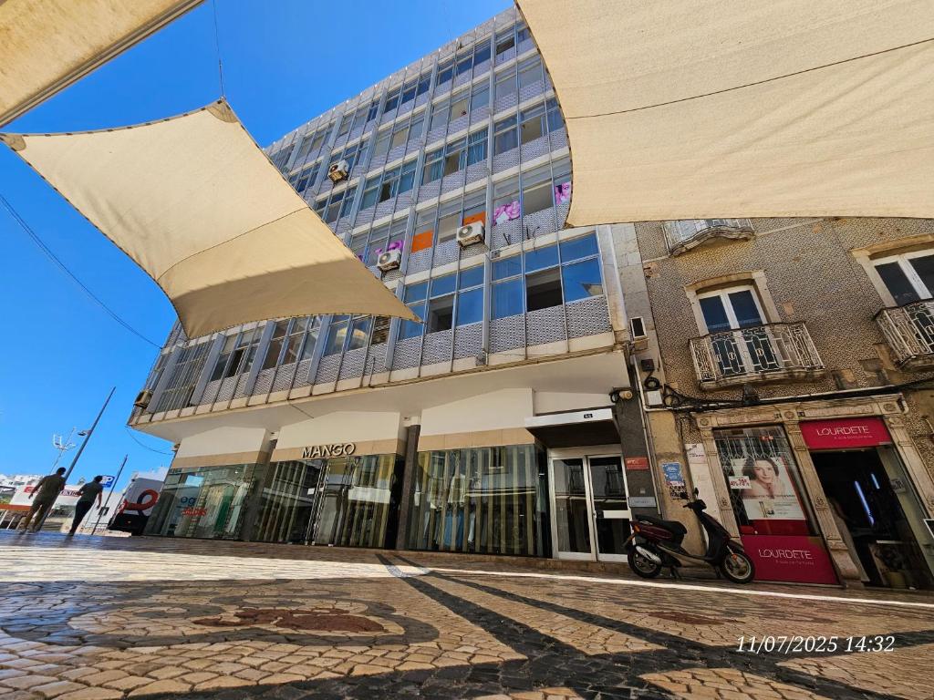 a building on a city street with a building at Blife Portugalya - private rooms at Santantonya 2nd floor in Faro