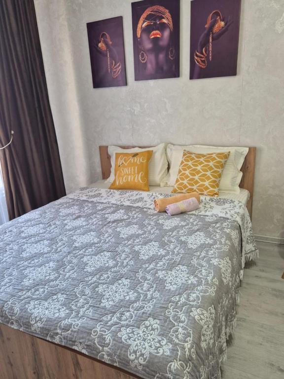 a bedroom with a bed with a blue comforter at Studio apartment for rent in Almaty
