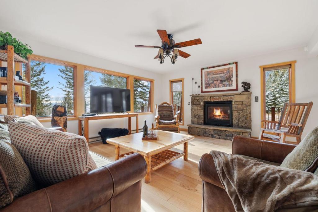 a living room with couches and a fireplace at RMR: Three Bear Tracks Home in Teton Village in Teton Village